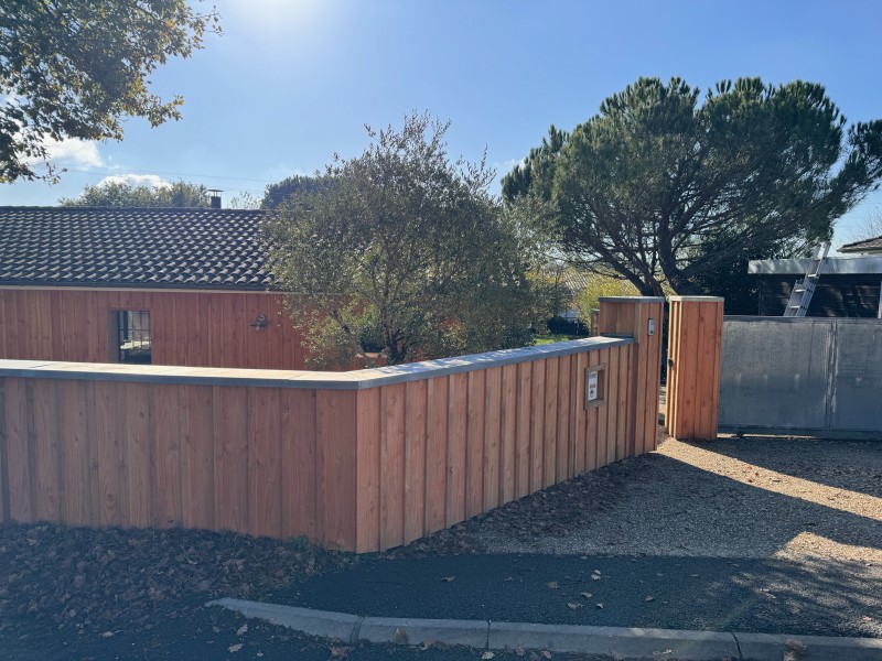 Clôture bois Douglas avec finition zinc – Artigues-près-de-Bordeaux Réalisation d’une clôture en bardage Douglas sur 20 mètres linéaires à Artigues-près-de-Bordeaux. Pose verticale des lames pour un rendu moderne et élégant, avec coiffe en zinc pour une f